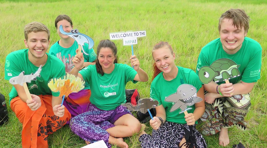 Projects Abroad Shark Conservation volunteers prepare material for an awareness campaign in Fiji.